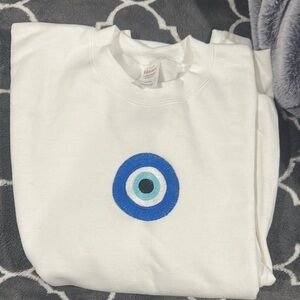 Women's embroidered crewneck NWT with Blue Evil Eye Design size SMALL